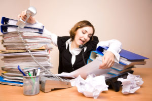 Stressed out woman multitasking at work